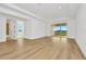 Large bedroom with wood-look floors and access to a balcony and additional room at 32354 Wetland Bird Vw, San Antonio, FL 33576