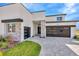 Modern two-car garage home with stone and neutral colors at 32354 Wetland Bird Vw, San Antonio, FL 33576