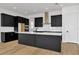 Modern kitchen with dark cabinetry, white quartz countertops, and a large island at 32354 Wetland Bird Vw, San Antonio, FL 33576