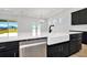 Modern kitchen island with white quartz countertop, farmhouse sink, and stainless steel dishwasher at 32354 Wetland Bird Vw, San Antonio, FL 33576