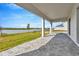 Covered patio overlooking a lake with paver stones at 32354 Wetland Bird Vw, San Antonio, FL 33576