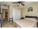 Well-lit bedroom with double doors and a ceiling fan at 5162 Bay Isle Cir, Clearwater, FL 33760