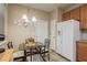 Small dining area with glass table and four chairs, near kitchen at 5162 Bay Isle Cir, Clearwater, FL 33760