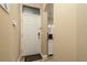 White front door with a welcome mat in a light-colored hallway at 5162 Bay Isle Cir, Clearwater, FL 33760