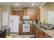 Kitchen features granite countertops, wood cabinets, and stainless steel appliances at 5162 Bay Isle Cir, Clearwater, FL 33760