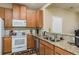 Kitchen with granite countertops, wood cabinets, and stainless steel appliances at 5162 Bay Isle Cir, Clearwater, FL 33760
