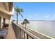 Spacious balcony overlooking the water with patio furniture at 7540 Sunshine Skyway S Ln # 220, St Petersburg, FL 33711