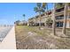 Waterfront building with palm trees and green space at 7540 Sunshine Skyway S Ln # 220, St Petersburg, FL 33711