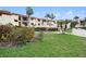Condo building with manicured lawn and lush landscaping at 7540 Sunshine Skyway S Ln # 220, St Petersburg, FL 33711