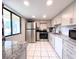 Bright kitchen with stainless steel appliances and granite countertops at 7540 Sunshine Skyway S Ln # 220, St Petersburg, FL 33711