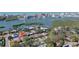 Aerial view of waterfront home with private pool and lush landscaping at 8134 Bayshore Dr, Seminole, FL 33776