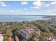 Aerial view features the building, surrounding trees, and the water and city in the background at 2650 Pearce Dr # 301, Clearwater, FL 33764