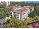 An aerial view of the building showcasing the apartments, balconies, and nearby trees at 2650 Pearce Dr # 301, Clearwater, FL 33764