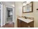 This bathroom features a vanity with a decorative backsplash and a view to the bedroom at 2650 Pearce Dr # 301, Clearwater, FL 33764