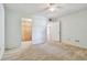 Bright bedroom with carpet, ceiling fan, walk-in closet, and multiple entryways at 2650 Pearce Dr # 301, Clearwater, FL 33764