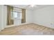 Cozy bedroom features neutral carpet, natural light, and ample space at 2650 Pearce Dr # 301, Clearwater, FL 33764