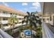 View from the building of a courtyard with a blue fountain, landscaping, and palm trees at 2650 Pearce Dr # 301, Clearwater, FL 33764