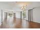 Spacious living room with hardwood floors, ceiling fan, and sliding glass doors to balcony at 2650 Pearce Dr # 301, Clearwater, FL 33764