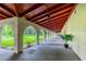 Exterior walkway featuring multiple archways and tropical vegetation at 2650 Pearce Dr # 301, Clearwater, FL 33764
