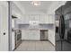 Modern kitchen featuring stainless steel appliances and white cabinetry at 3714 Greenery Ct # 214, Tampa, FL 33618