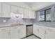 Clean kitchen with white cabinets, stainless steel appliances, and a double sink at 3714 Greenery Ct # 214, Tampa, FL 33618