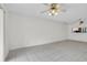 Living room with tile floors and ceiling fan, access to kitchen at 3714 Greenery Ct # 214, Tampa, FL 33618
