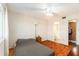 A cozy bedroom features tile floors, a large bed, and a view into the bathroom at 801 83Rd N Ave # 511, St Petersburg, FL 33702