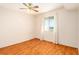 Bedroom featuring tile floors, a window with sheer curtains, and a ceiling fan at 801 83Rd N Ave # 511, St Petersburg, FL 33702
