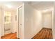 Hallway featuring wood-look floors, a closet, and a view into the bathroom at 801 83Rd N Ave # 511, St Petersburg, FL 33702