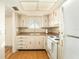 The kitchen is equipped with white appliances, bright lighting, and wood floors at 801 83Rd N Ave # 511, St Petersburg, FL 33702