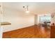 A large living room with wood floors, views of a piano and access to other rooms at 801 83Rd N Ave # 511, St Petersburg, FL 33702
