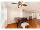 Open living room with a ceiling fan, wood floors, and a view of the hallway and kitchen at 801 83Rd N Ave # 511, St Petersburg, FL 33702