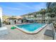 Exterior shot of a pristine community pool, palm trees, and a multi-story building at 801 83Rd N Ave # 511, St Petersburg, FL 33702