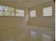 Bright bedroom with multiple windows and terrazzo flooring at 105 Causeway Blvd, Belleair Beach, FL 33786