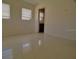 Bedroom with bathroom access and terrazzo flooring at 105 Causeway Blvd, Belleair Beach, FL 33786