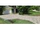 Newly paved driveway with a drainage system at 105 Causeway Blvd, Belleair Beach, FL 33786