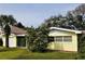 Front view of ranch-style house with a well-maintained lawn at 105 Causeway Blvd, Belleair Beach, FL 33786