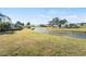 Backyard view of property, showcasing canal and golf course views at 418 Cardiff Rd, Venice, FL 34293