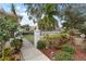 Attractive gated entrance with walkway and manicured landscaping at 418 Cardiff Rd, Venice, FL 34293