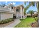 Two-story house with walkway, landscaping, and partial view of the garage at 418 Cardiff Rd, Venice, FL 34293