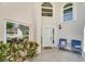 Front entrance with white door, sitting area, and potted plants at 418 Cardiff Rd, Venice, FL 34293
