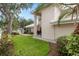 Landscaped front yard with lush lawn and mature trees at 418 Cardiff Rd, Venice, FL 34293
