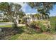 Attractive home exterior with lush landscaping and gated entry at 418 Cardiff Rd, Venice, FL 34293