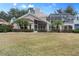 House back view with large backyard and screened enclosure at 418 Cardiff Rd, Venice, FL 34293