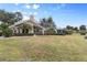 Beautiful home exterior with lush landscaping and backyard at 418 Cardiff Rd, Venice, FL 34293