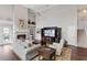 Living room with hardwood floors, fireplace, and built-in entertainment center at 418 Cardiff Rd, Venice, FL 34293
