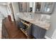 Elegant wet bar with marble top and pull-out drawers for liquor and wine storage at 418 Cardiff Rd, Venice, FL 34293