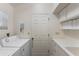 Bright laundry room features a modern washer and dryer, ample storage, and a functional countertop at 418 Cardiff Rd, Venice, FL 34293