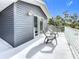 Private balcony with two gray adirondack chairs and sliding glass doors at 1044 Rosetree Ln, Tarpon Springs, FL 34689