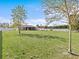 Expansive grassy backyard with trees and privacy fence at 708 Tower Grove Dr, Plant City, FL 33567